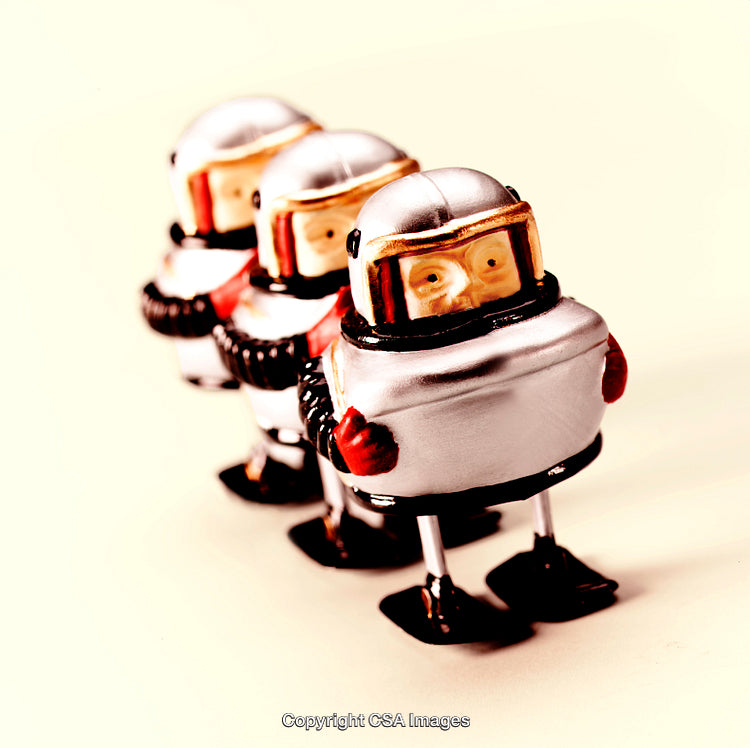 Toy Robots in a Row Over Light Background