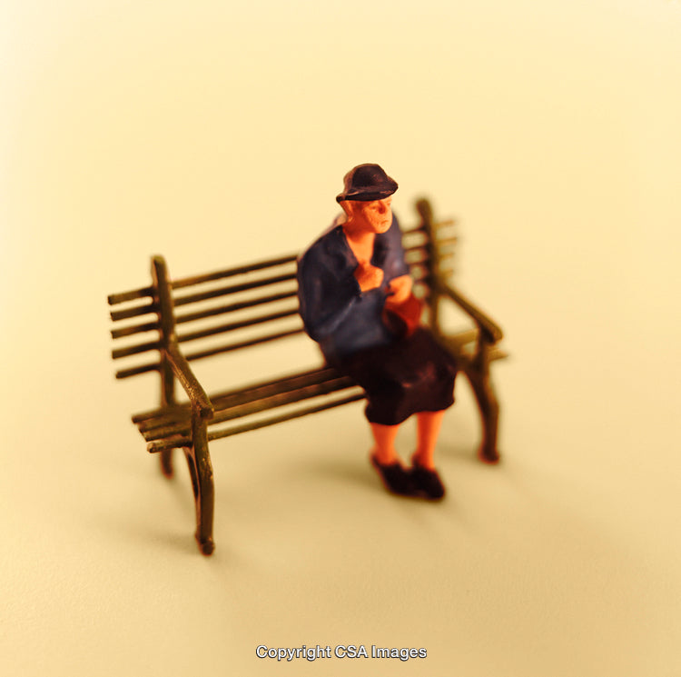 Miniature Figure of a Woman Sitting on a Wooden Bench