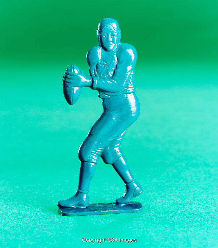 Blue Plastic Toy Football Figurine on Bright Green Background