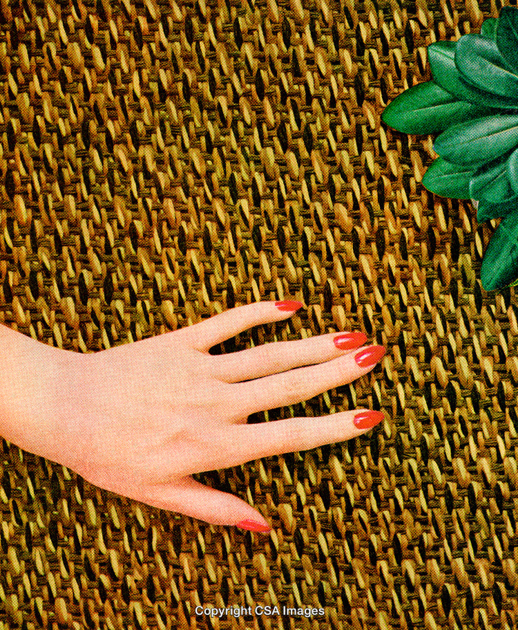 Close-Up of Manicured Hand on Textured Surface with Green Accents