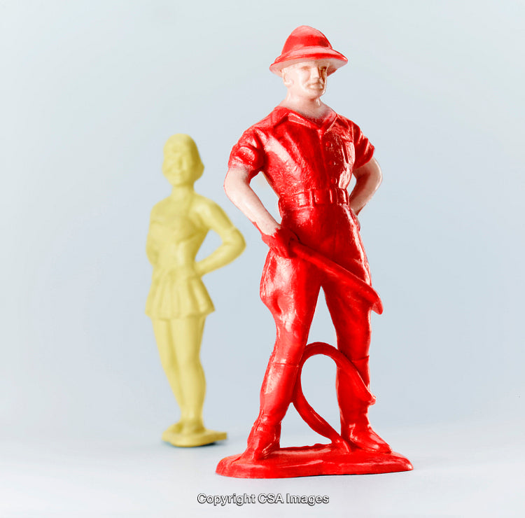 Close-Up of Red and Yellow Plastic Toy Figures Against Light Background