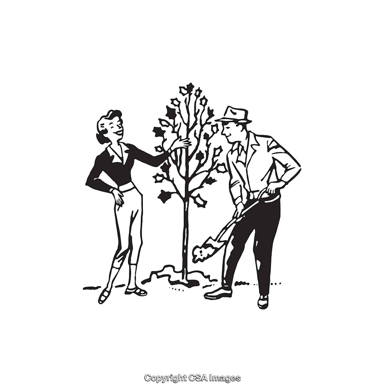 Couple Gardening Together While Planting a New Tree