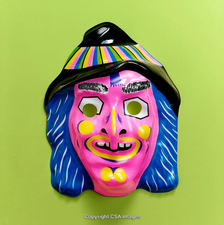Colorful Cartoon Witch Mask on Bright Green Background Close-Up Art