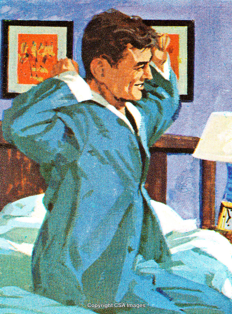 Man Stretching in Bed After Waking Up in Comfortable Nightwear