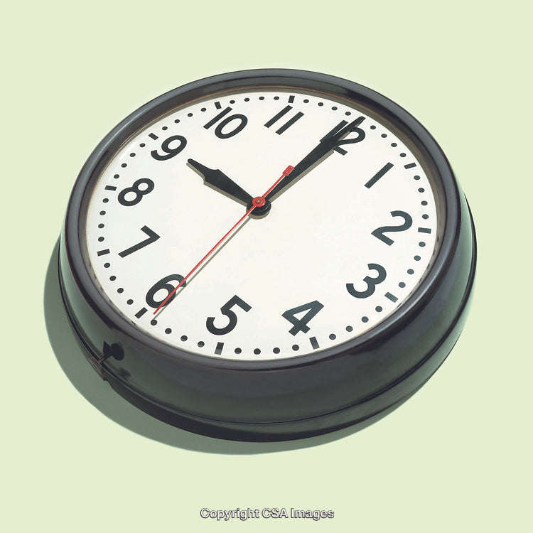 Retro Wall Clock Displayed Against Solid Light Green Background