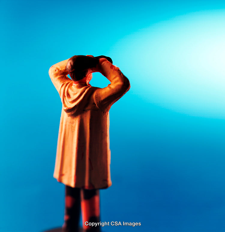 Miniature Figure Observing Through Binoculars Against Vibrant Blue Background