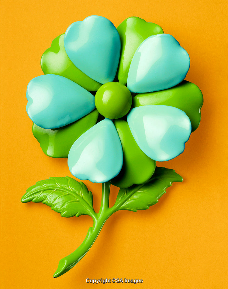 Colorful Plastic Flower With Blue Petals and Green Leaves on Orange Background