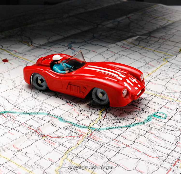 Red Toy Car on a Detailed Map Displaying Travel Representation