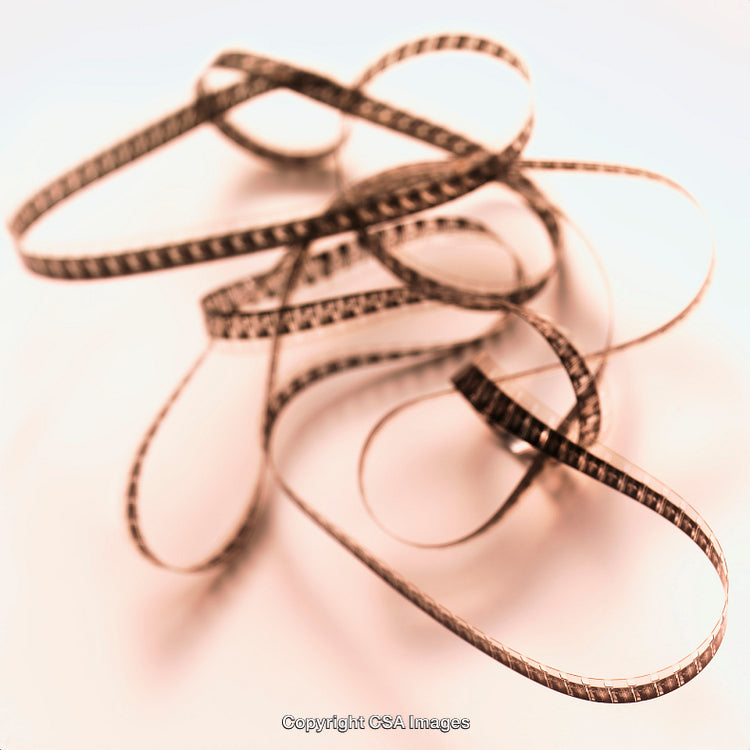 Close-Up of Entangled Film Strip on Minimalist Background
