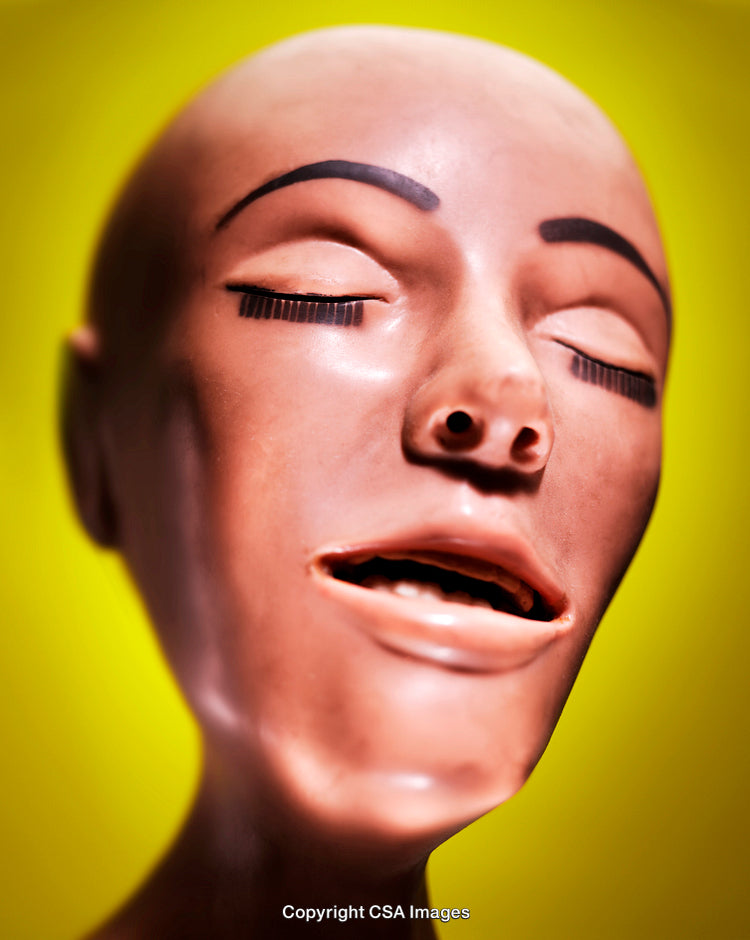 Close-Up of Abstract Plastic Facial Model With Yellow Background