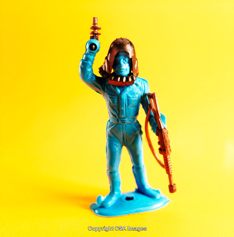 Vintage Blue Plastic Toy Soldier Against Yellow Background
