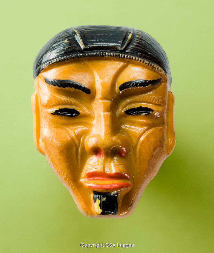 Close-Up of a Figurative Face Mask on Green Background