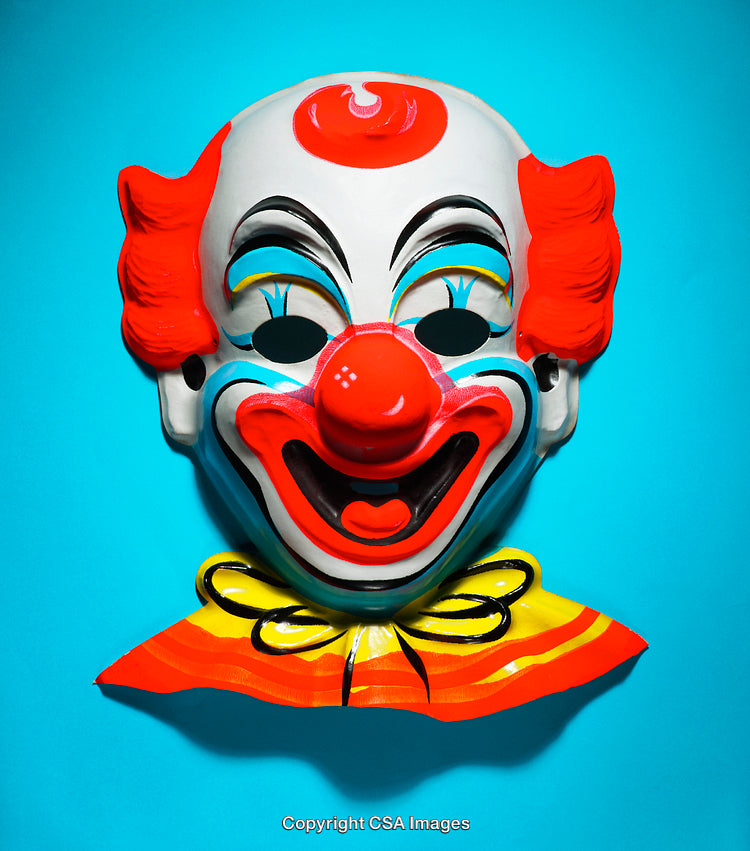 Brightly Colored Plastic Clown Mask Isolated on Vibrant Blue Background