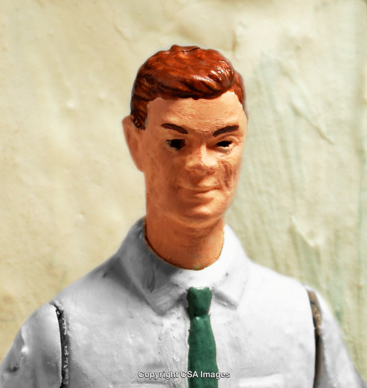 Close-Up of a Hand-Painted Plastic Toy Figurine in Formal Attire