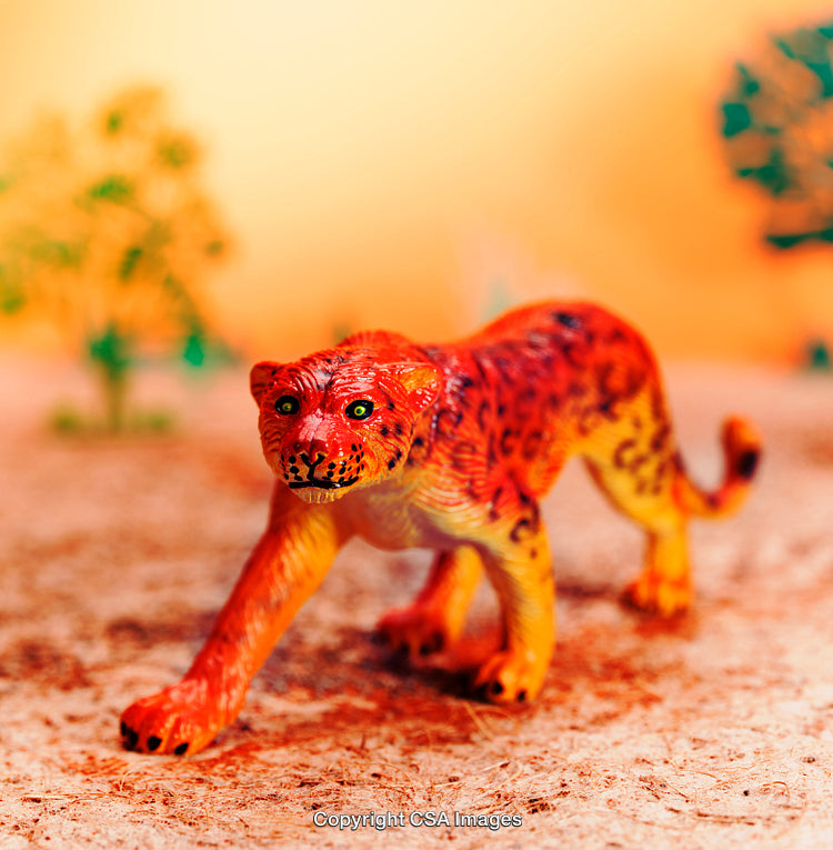 Colorful Plastic Leopard Toy Displayed on a Scenic Safari Background
