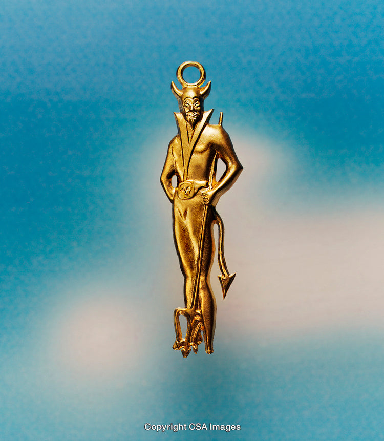Gold Devil Figurine Against a Bright Sky Background