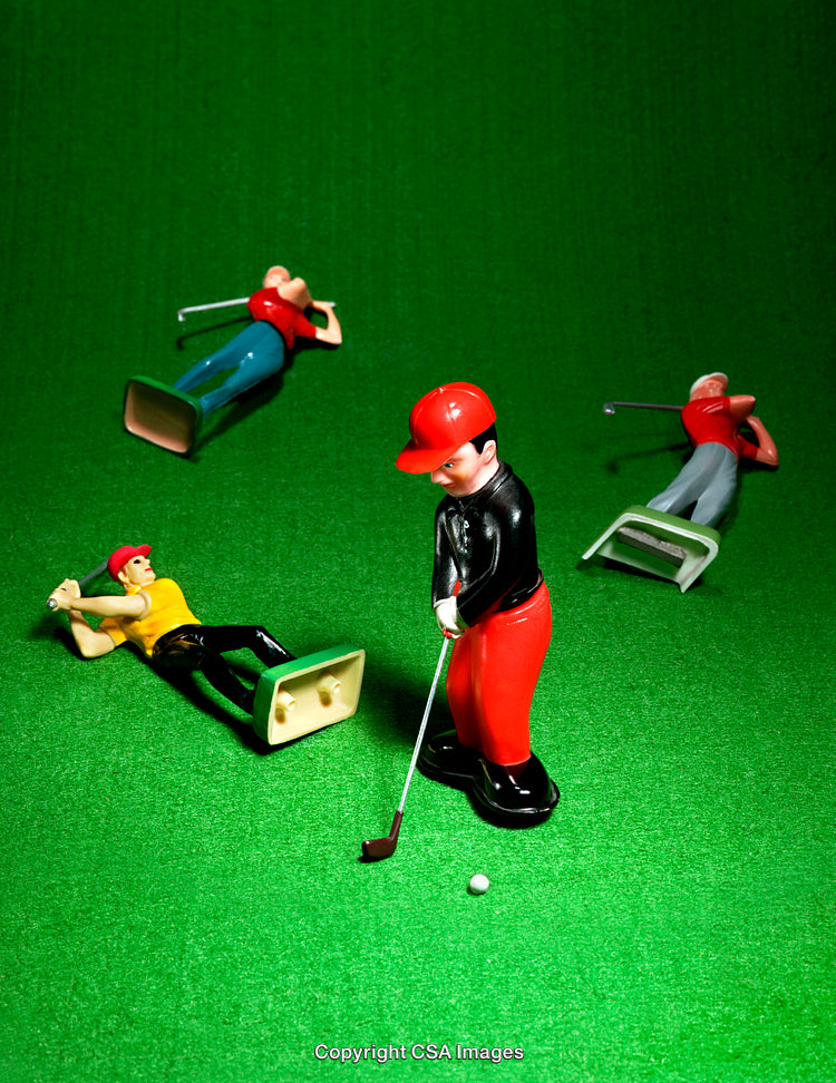 Colorful Plastic Golf Figurines on Green Background in Playful Arrangement