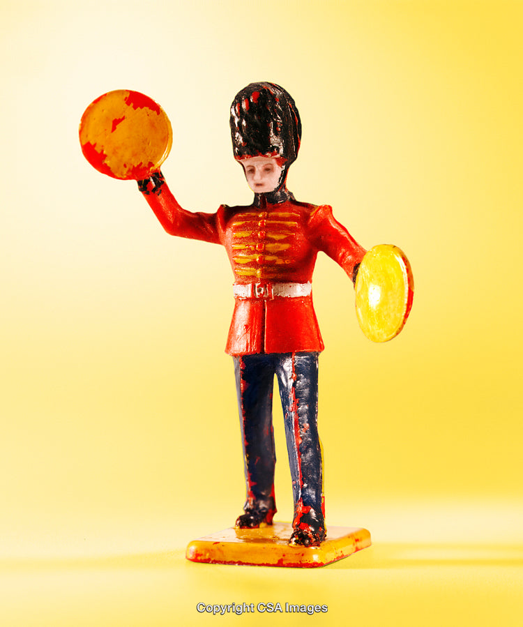 Vintage Plastic Toy Soldier with Cymbals on Yellow Background