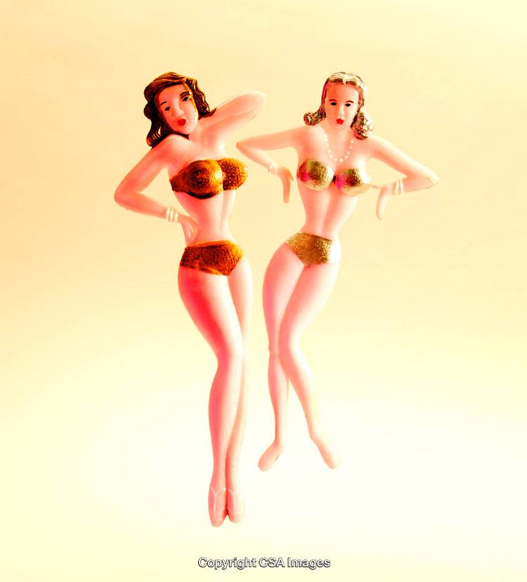 Retro Styled Plastic Figurines with Golden Swimwear on Bright Background