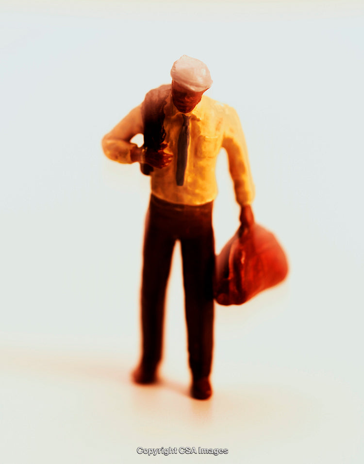 Miniature Figure of Man Holding Bag in Warm Lighting
