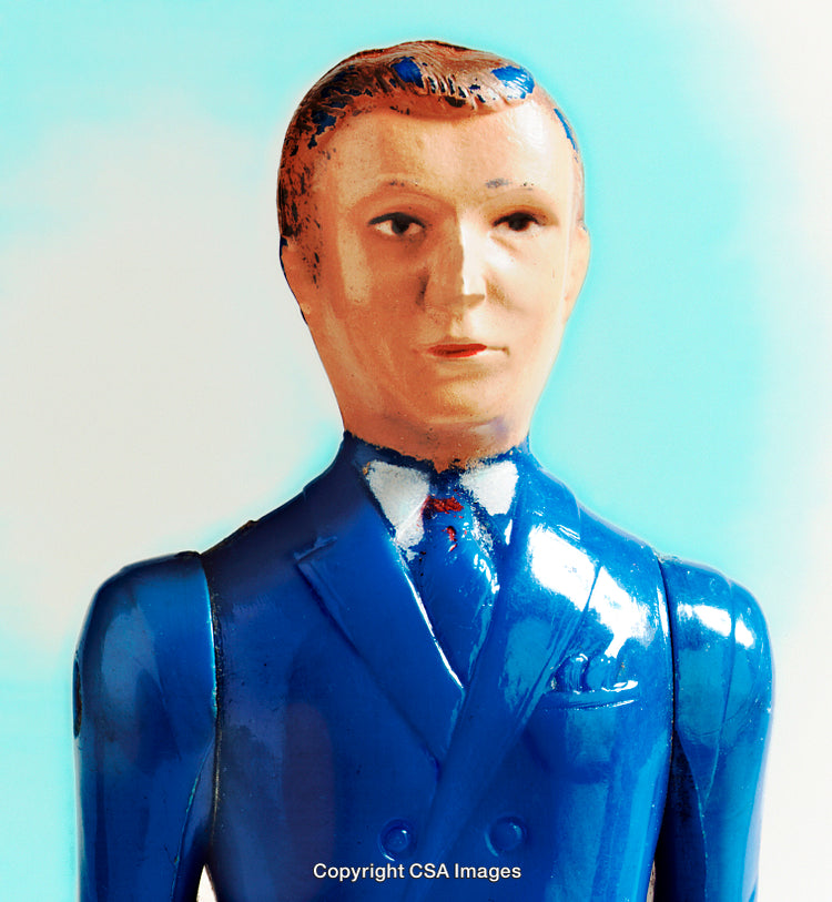 Vintage Plastic Toy Figure in Blue Suit on Pastel Background