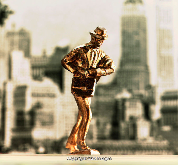 Golden Vintage Statuesque Figure Against Urban Architectural Backdrop