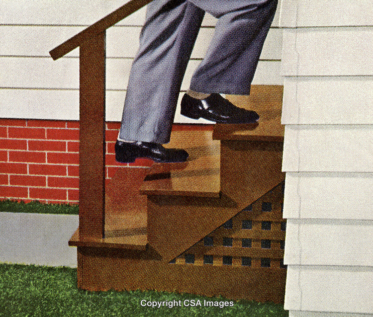 Man in Business Attire Ascending Outdoor Wooden Stairs at a House