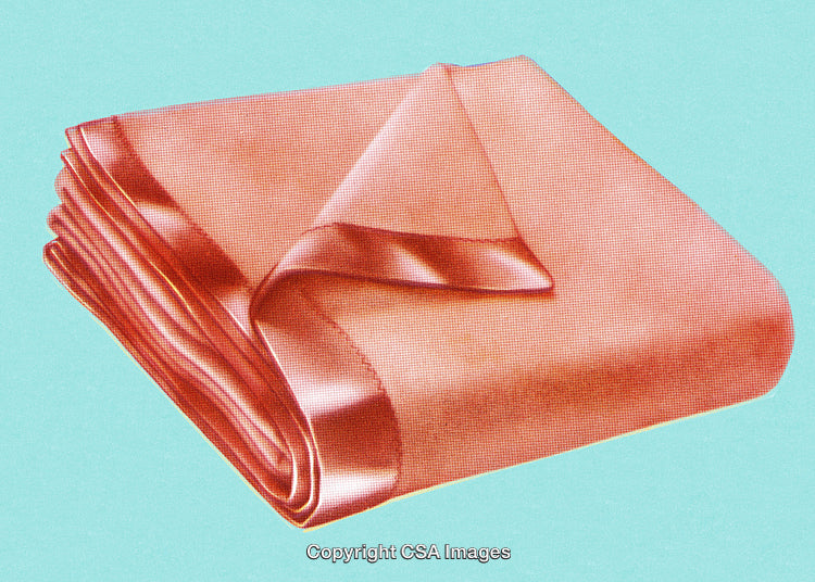 Elegant Folded Pink Silk Blanket on Vibrant Light Blue Background