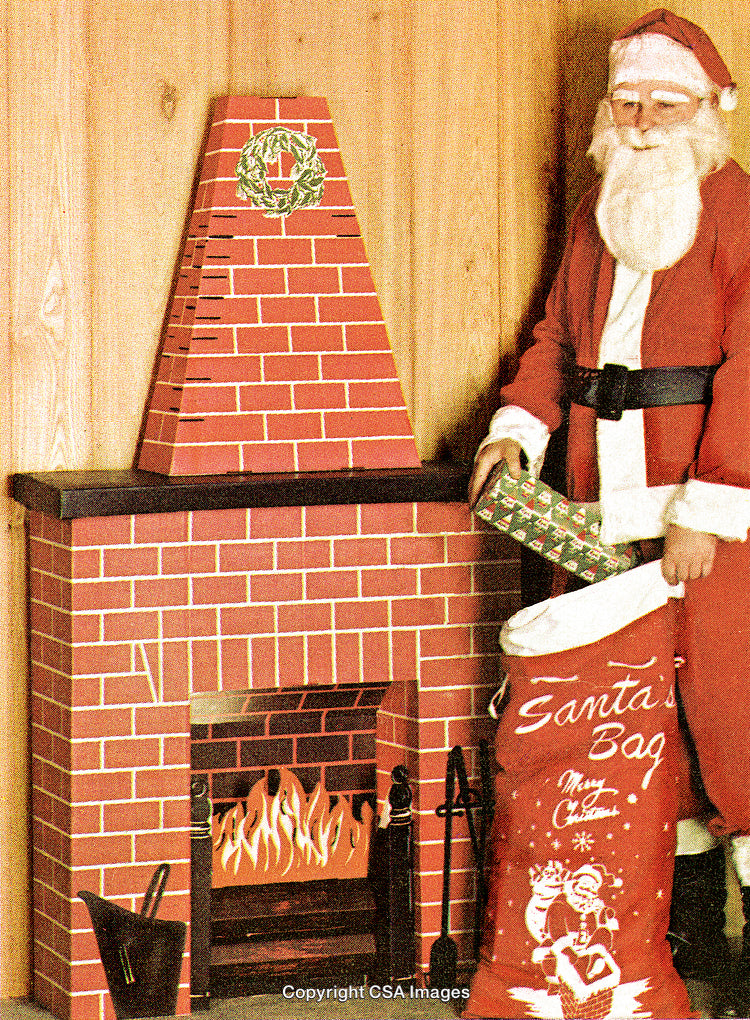Santa Claus Next to Fireplace with Holiday Sack and Decorative Wreath