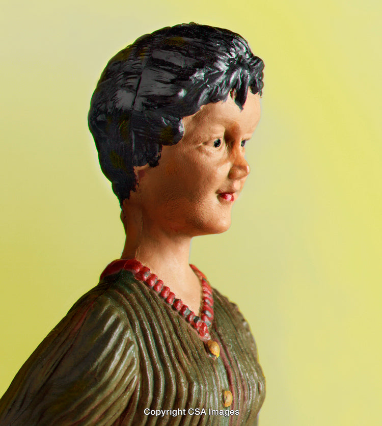 Close-up of a Vintage Figurine with a Yellow Background