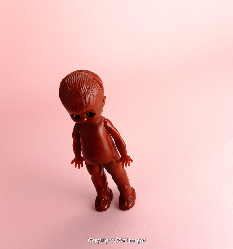 Minimalist Photo of a Vintage Doll on Light Pink Background