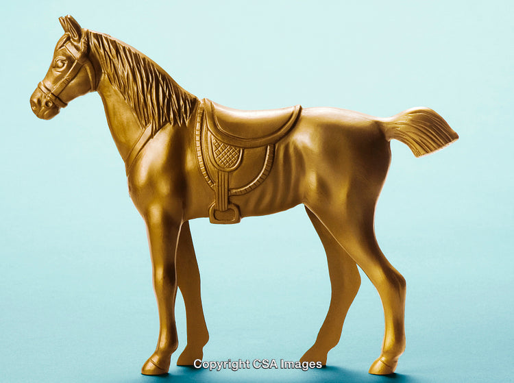 Golden Plastic Horse Figurine on a Light Blue Background