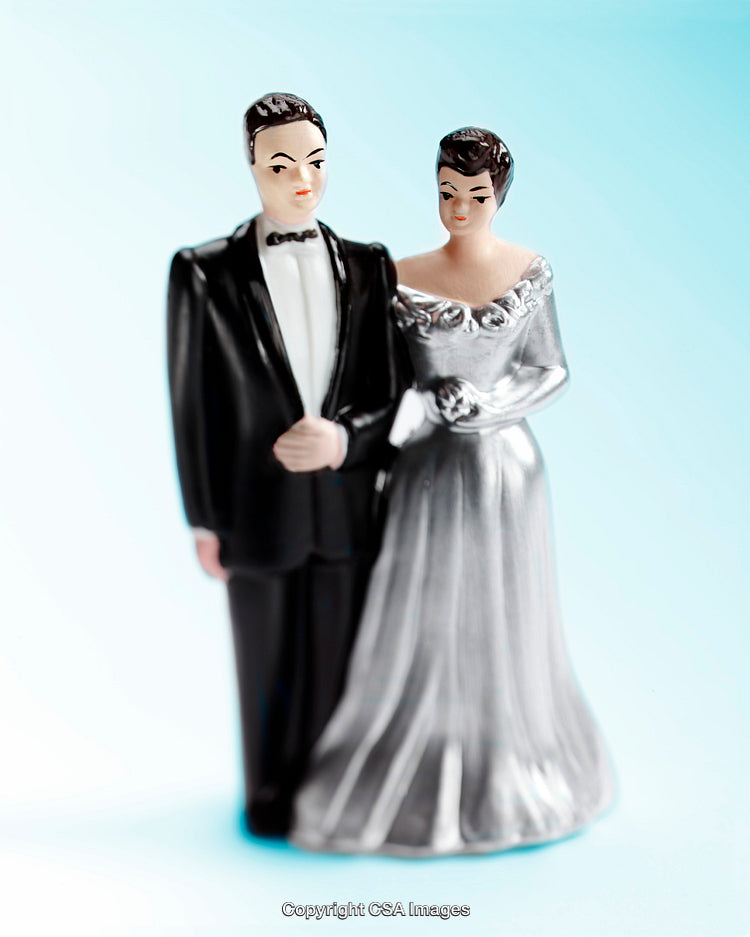 Plastic Bride and Groom Figures on Light Blue Background