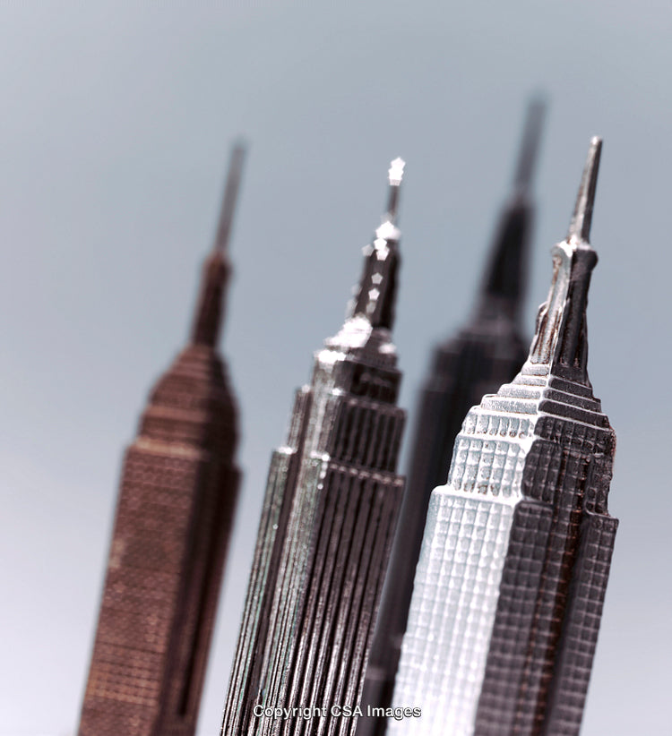 Close-Up of Metallic Miniature Skyscraper Models Against Blurred Background