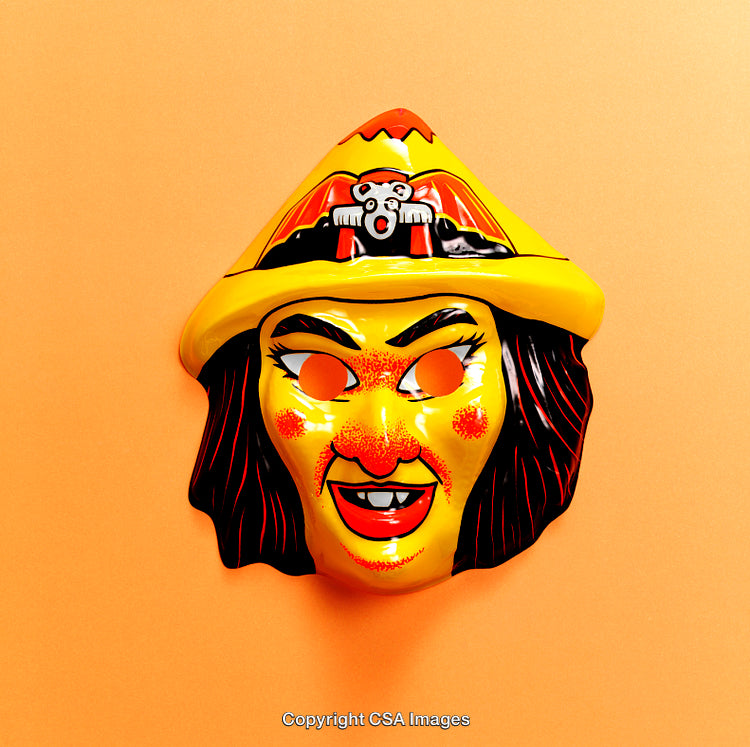 Brightly Colored Toy Witch Mask on an Orange Background