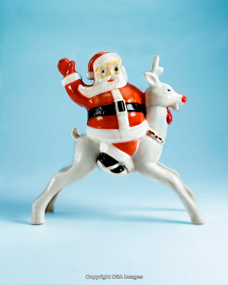 Santa Claus Riding a White Reindeer Christmas Figurine on Blue Background