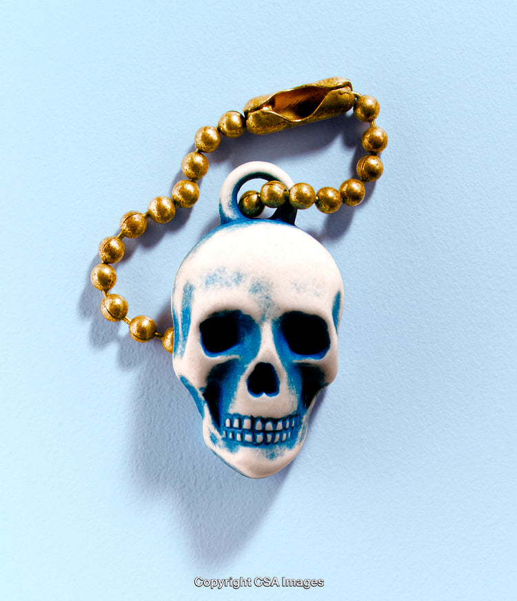 Gold Chain with Blue Skull Pendant on a Light Blue Background