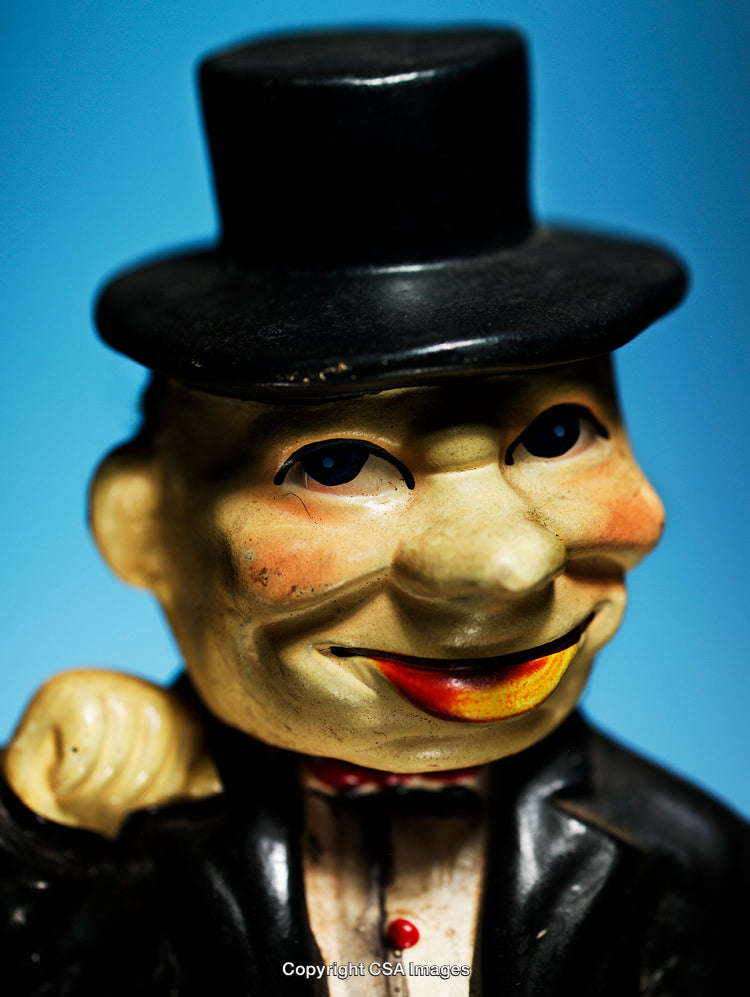 Vintage Plastic Toy Figure in a Black Suit and Hat on Blue Background