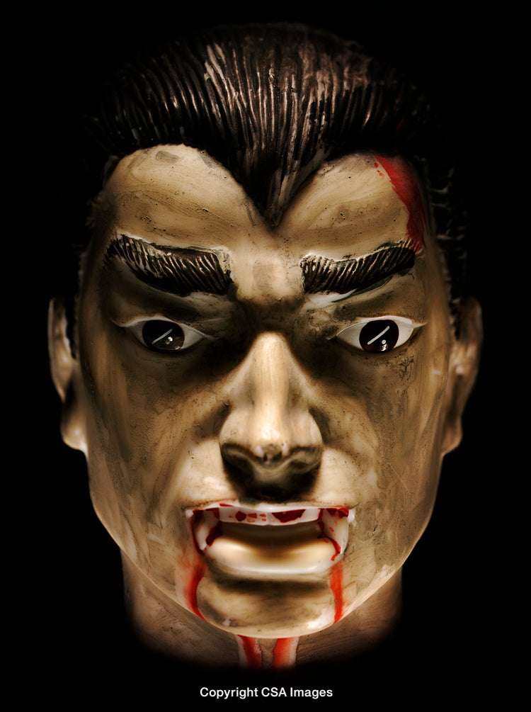 Close-Up of a Dracula-Like Vampire Mask with Fangs and Fake Blood