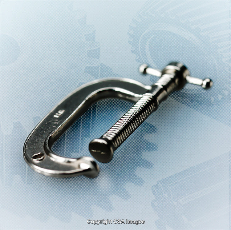 Close-Up of a Metal C-Clamp on a Gear Background