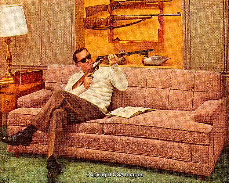 Man Sitting on Couch Holding Rifle in Vintage Style Photograph