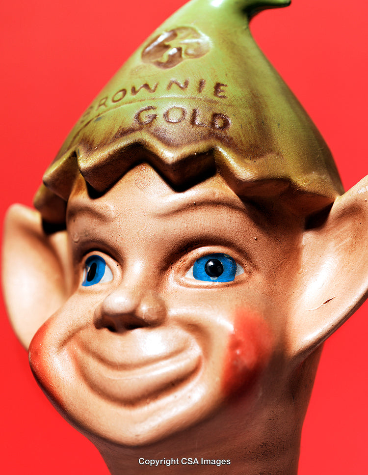 Close-Up of a Cheerful Elf Figurine Against a Vibrant Red Background