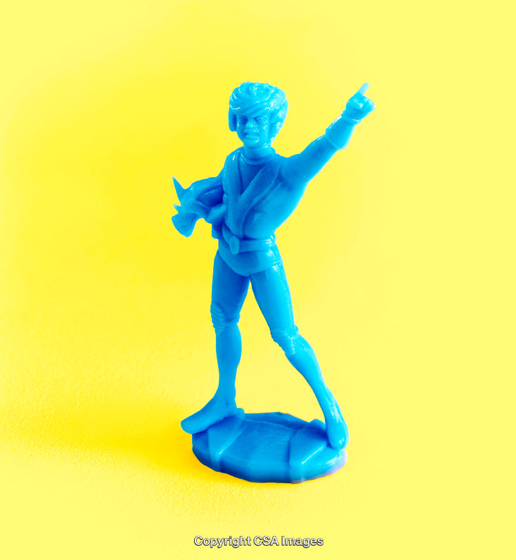 Blue Plastic Toy Figure on Vibrant Yellow Backdrop