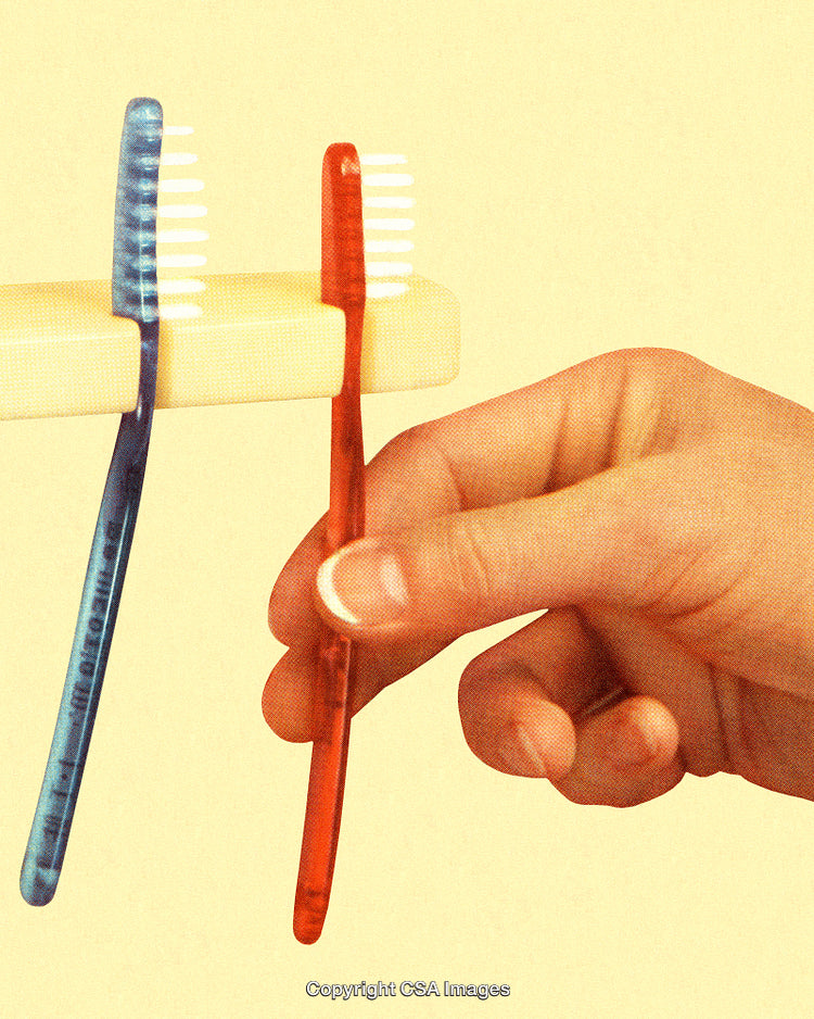 Hand Placing a Red Toothbrush on Bathroom Holder in Stylish Vintage Style