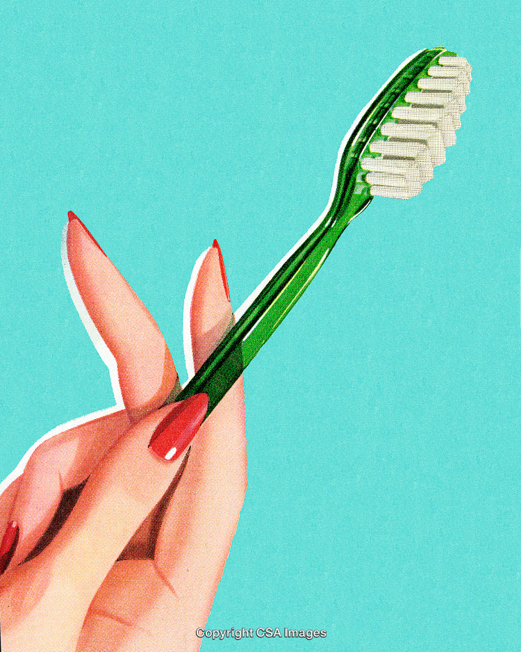 Hand Holding Green Toothbrush Against a Solid Light Blue Background