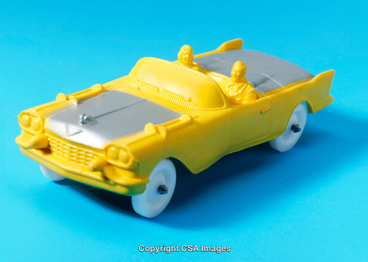 Yellow Retro Toy Car On a Vibrant Blue Background