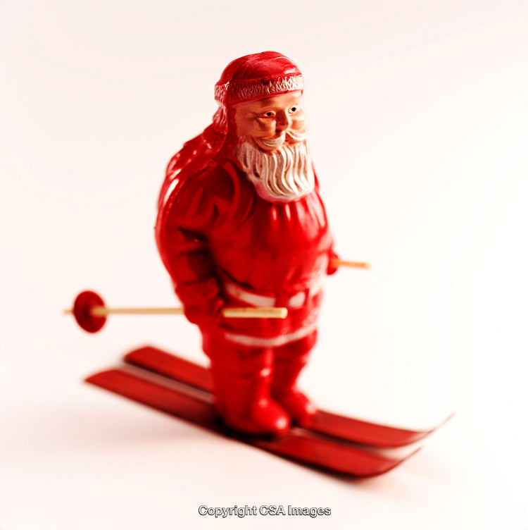 Festive Santa Claus Figurine on Skis with White Background