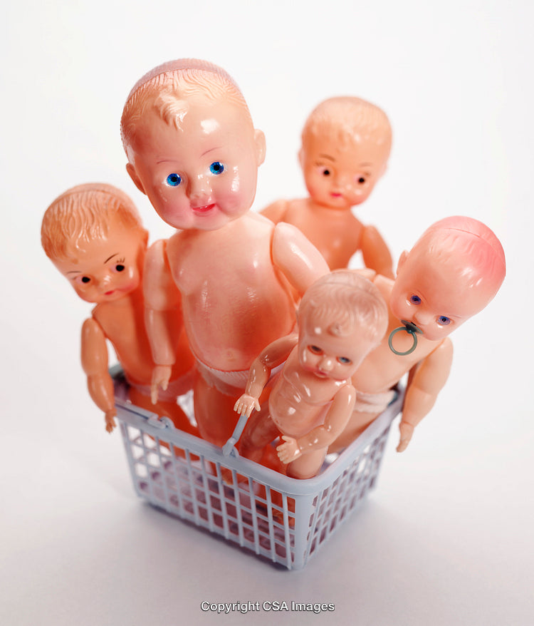 Group of Vintage Plastic Baby Dolls in a Small Basket