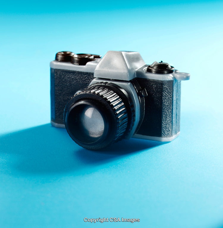 Close-Up of a Toy Camera on a Vibrant Blue Background