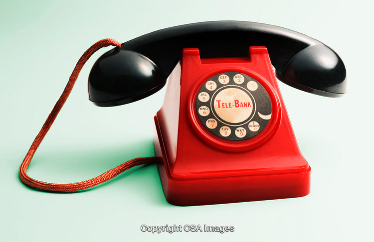 Vintage Red Toy Telephone with Rotary Dial on a Light Background